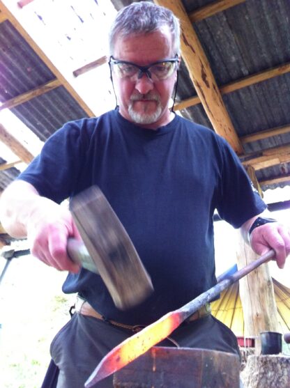 John forging an iron blade